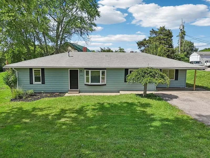 Same rental property after EZ Rent Now rehab &mdash; fresh paint, clean yard, move-in ready
