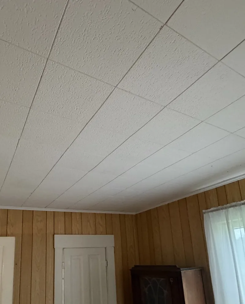 Same ceiling after EZ Rent Now repair &mdash; fully patched and tiled, move-in ready